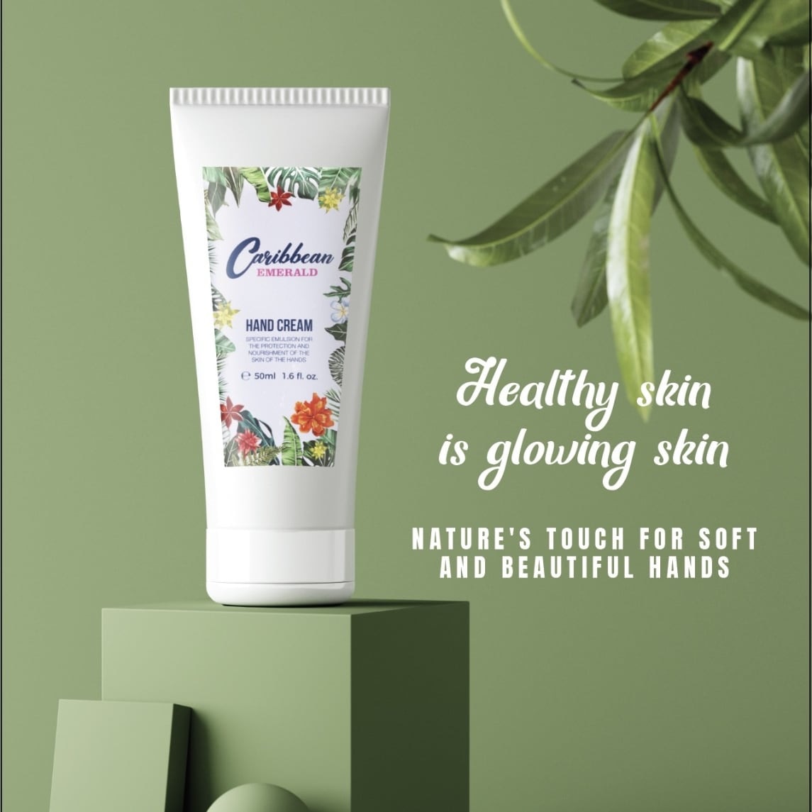 Tube of Caribbean Emerald natural and clean beauty hand cream on a green platform with leaves, promoting healthy skin.