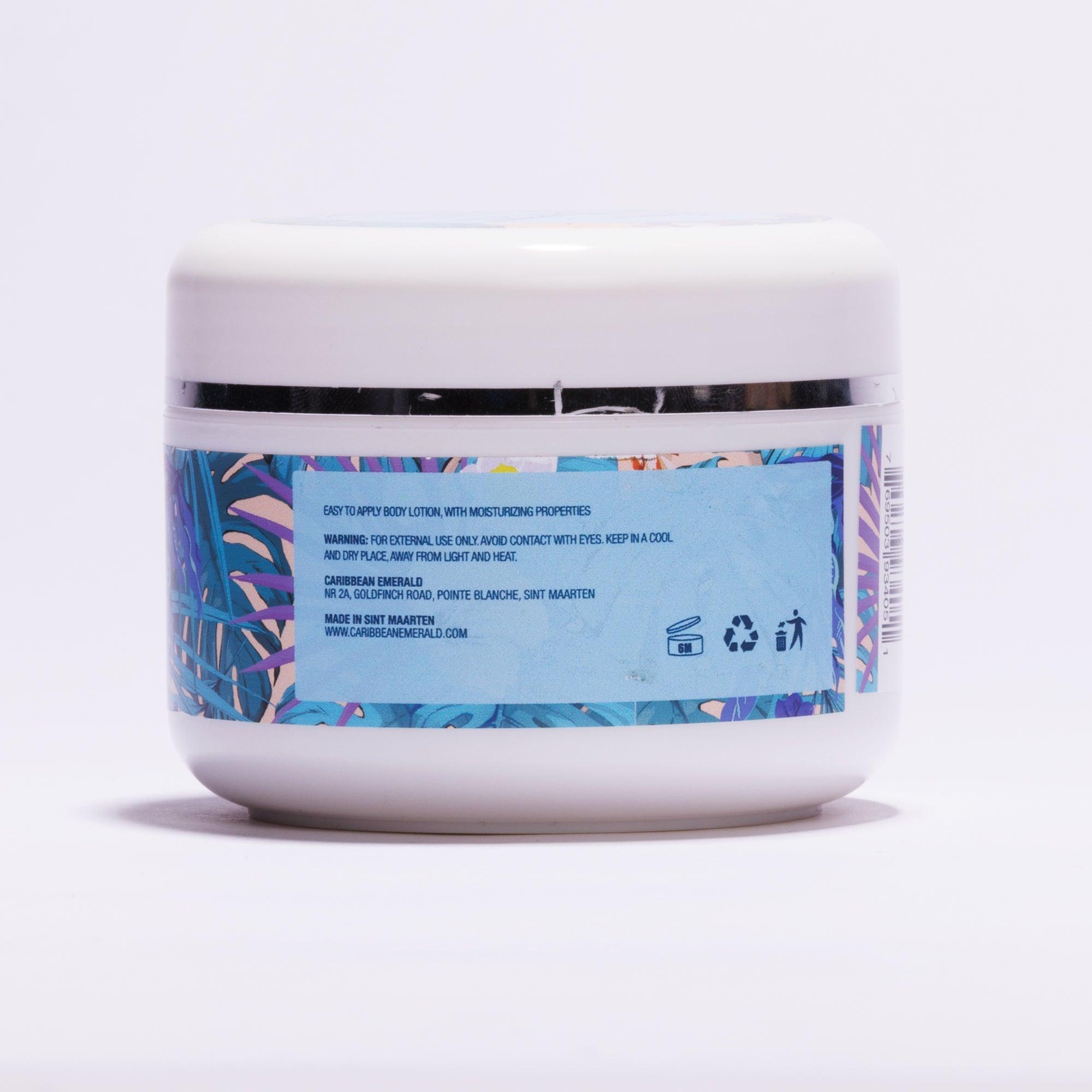 Back view of a white moisturizing body lotion jar with tropical leaf pattern label.