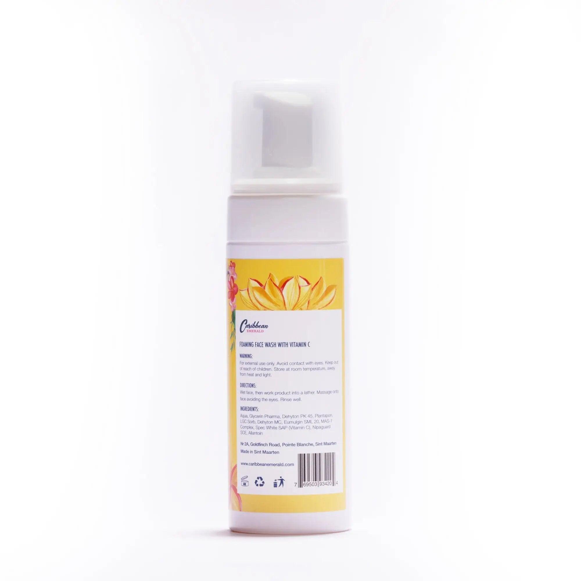 White foaming face wash bottle with Vitamin C and tropical flower label.
