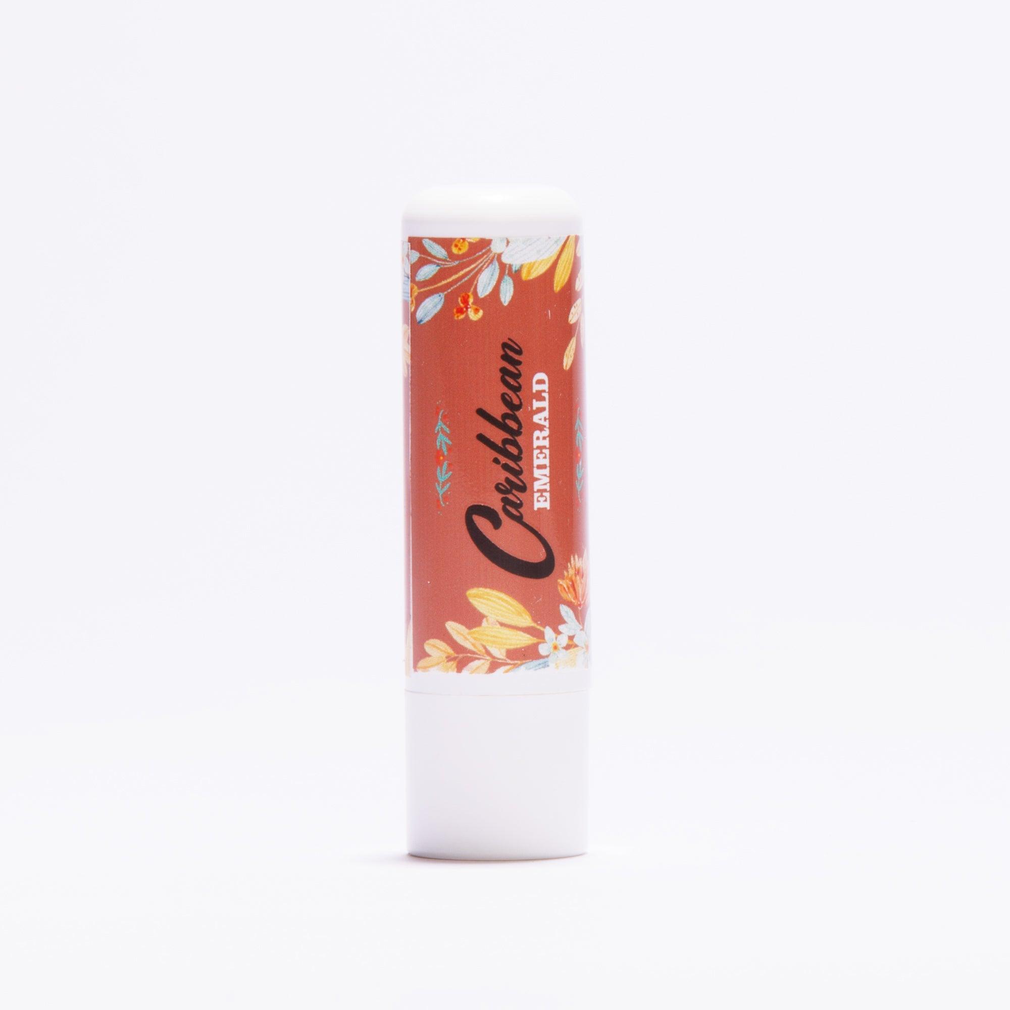 Caribbean Emerald lip balm tube with floral pattern on a white background
