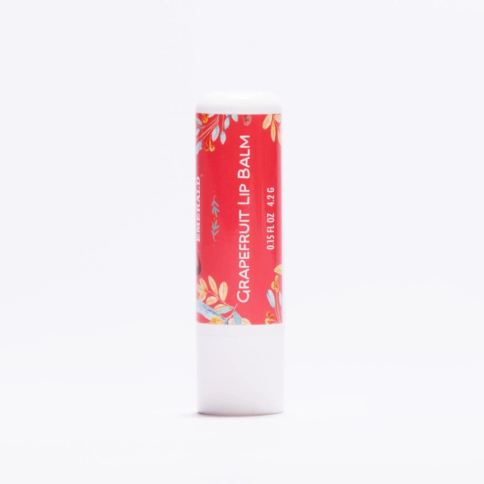 Grapefruit lip balm tube with red floral design on a white background