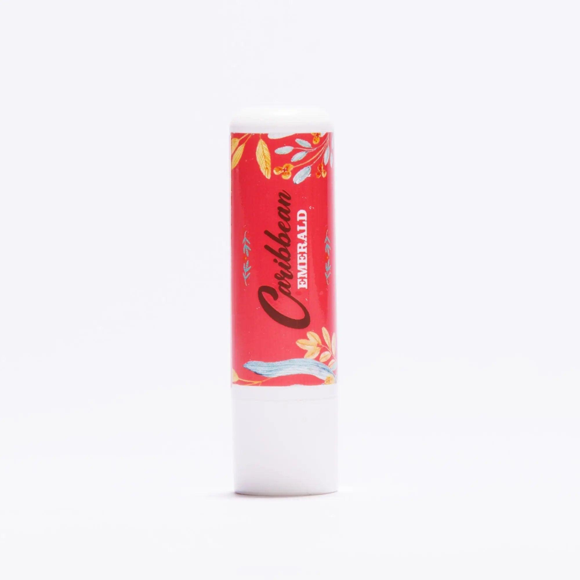 Caribbean Emerald lip balm in a red floral patterned tube on a white background
