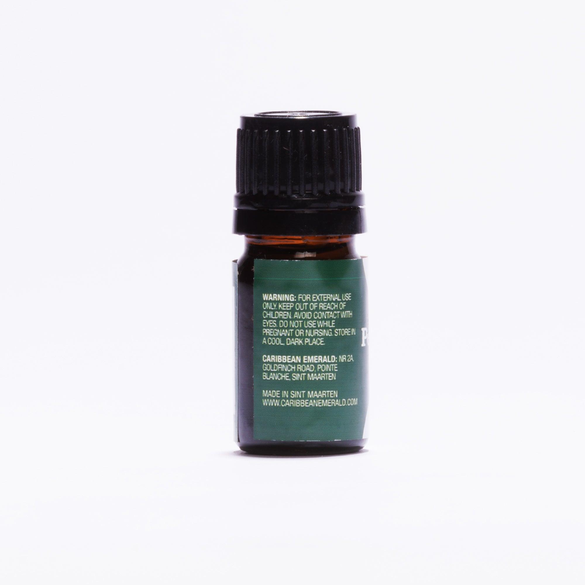 Small amber glass bottle with a black cap and green label for natural skin care products.